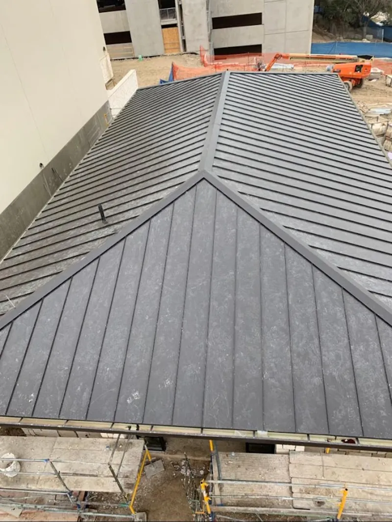 Commercial metal roof construction with crane equipment in Plattsmouth