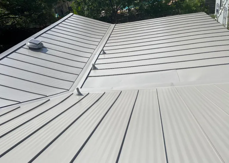 Solar attic fan installed on a metal roof for Roof Ventilation in Plattsmouth